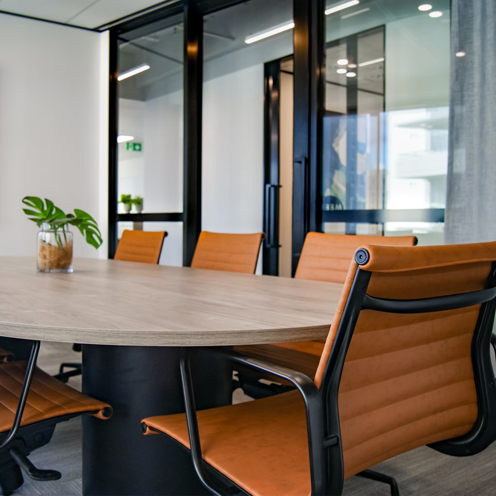 Quiet boardroom with a round table and leather chairs